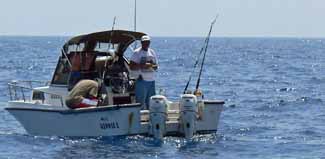 two anglers enjoying a saltwater fishing trip at anchor off Anguilla in the West indies